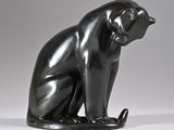 sculpture of a black cat sitting on a white surface