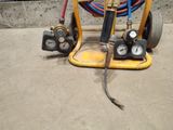 a yellow cart with two hoses and a hose on it