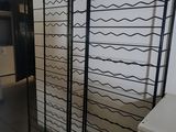 an image of a room with a rack of wine bottles