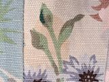 a close up of a flowered fabric on a table cloth
