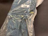 a bag of blue clothing wrapped in plastic on the floor