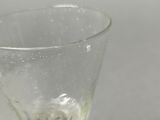 a wine glass that is sitting on a table