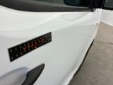 a close up of a white car with a sticker on it