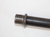 a metal pipe with a ring on it on a white surface