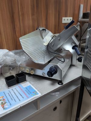 an image of a commercial pizza cutter on a counter