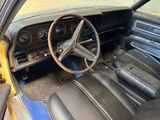 a steering wheel and dashboard of a car in a garage