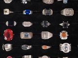 a display of various rings on display in a case