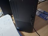 a desktop computer sitting on a desk with a lot of papers on it