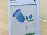 a picture of a picture of a blue flower in a box