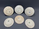 six plates with different designs on them on a gray surface
