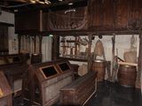 a room with wooden benches and wooden barrels in it