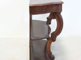 a small wooden table with a shelf on top of it
