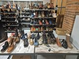 many pairs of shoes sitting on a table in a room