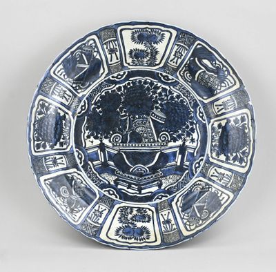 a blue and white plate with a design on it