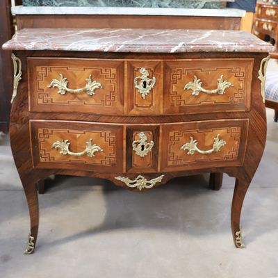 a marble top chest of drawers in a store