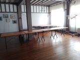 a room with tables and chairs in it and a chandelier