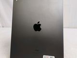 an apple ipad is sitting on a stand on a white surface