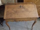 a small wooden table with a drawer on top of it