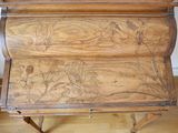 a small wooden desk with a drawer on top of it