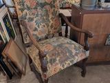 a chair that is sitting in a room with pictures on the wall