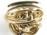a close up of a gold ring on a white surface