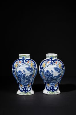 pair of blue and white vases with figures in a landscape