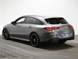 the rear end of a silver mercedes cla parked on a checkered floor
