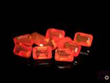 a lot of red plastic cubes on a black surface