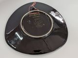a black plate with a picture of a horse on it