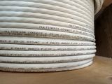 a stack of white wires on top of a wooden table