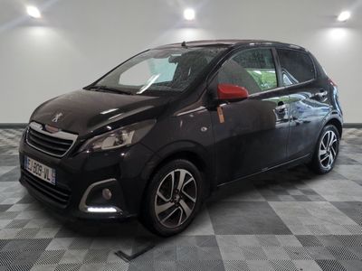 the small black car is parked in a room with a checkered floor