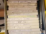 a lot of books in a box with writing on them