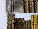 many different types of drill bits arranged in a row