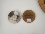 two pieces of glass sitting on a white surface