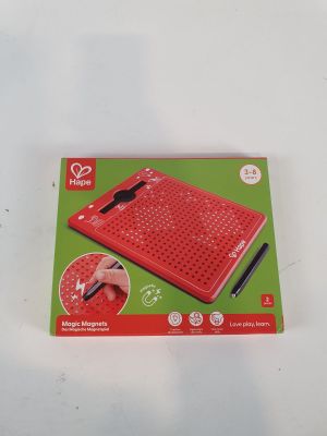someone is using a pen to write on a red electronic keyboard