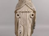 an old statue of a woman with a veil on her head