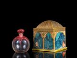 an image of a small glass bottle with a lid and a small glass container with a painting on it