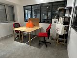 a room with a table, chairs, and a window