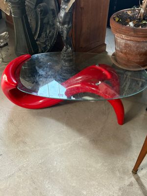 a glass table with a red object on top of it