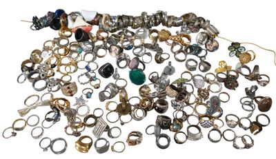 a pile of rings and other jewelry on a white surface