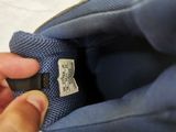 a person holding a blue bag with a label on it