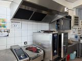 a kitchen with a stove, oven, and other appliances in it