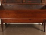 an old wooden chest with a drawer on top of it