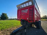 a red trailer that is parked on the side of the road