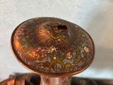 a bronze figurine of a horse with a hat on it ' s head