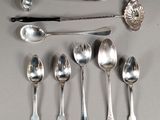 a lot of silver spoons and spoon spoons on a table