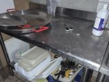 a kitchen with a sink and a metal counter top