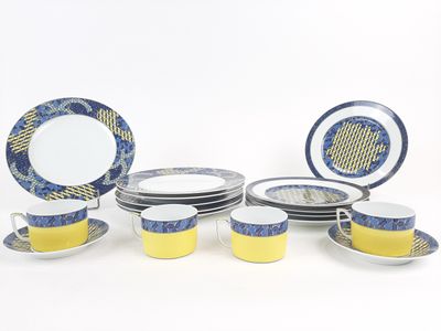 a lot of plates and cups that are sitting on a table