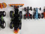 several toy vehicles are lined up on a white surface