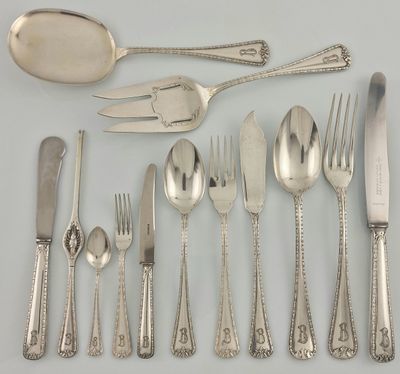 a lot of silverware on a table with a spoon and fork